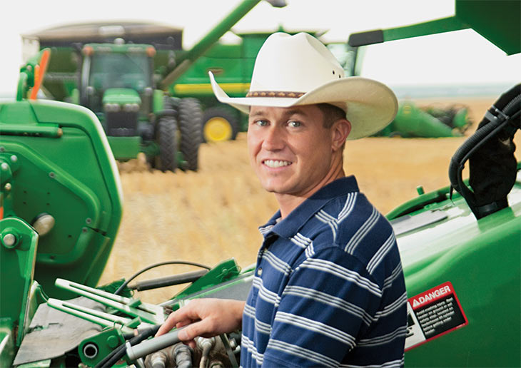 Paul Minzenmayer with some green farm equipment