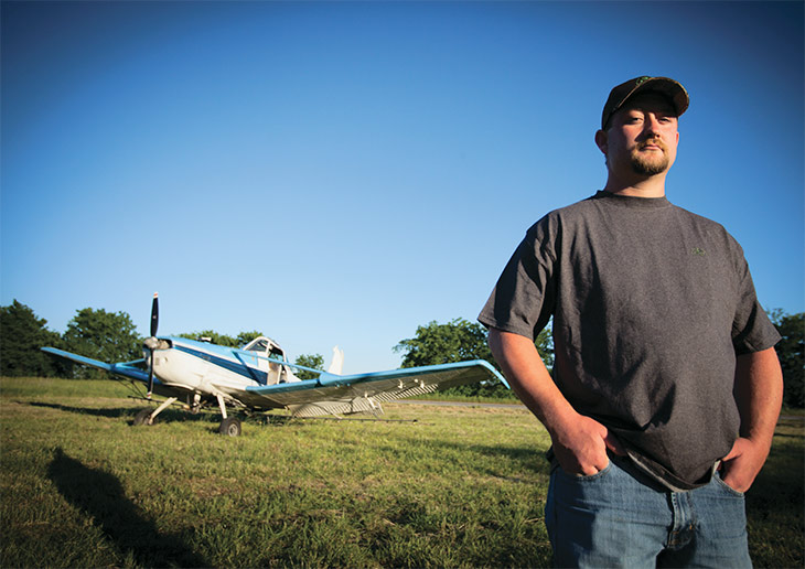 Jesse Shipman standing in front of a cropduster