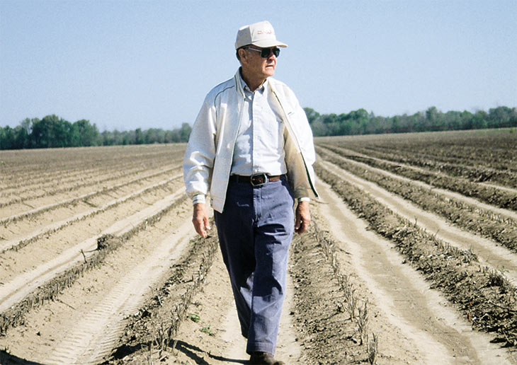 Ray Young walks a plowed field