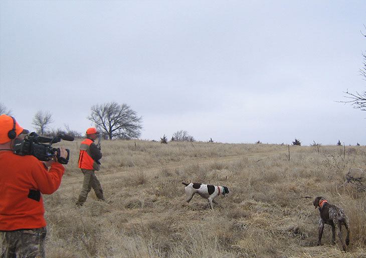 Cameraman films Jeff Ensor with dogs