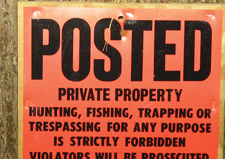 Orange no trespassing sign