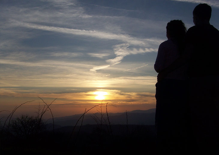 Sunset with people's backs in foreground