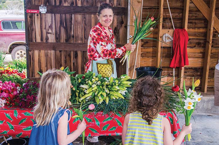 Pamela Arnosky answers questions from young flower shoppers.