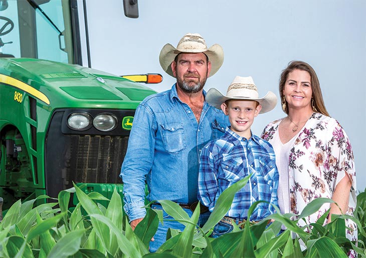Mangold family in front of tractor
