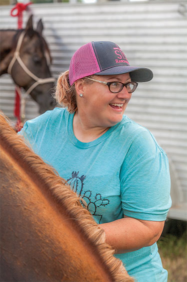 Amy Hegeman tends to horse