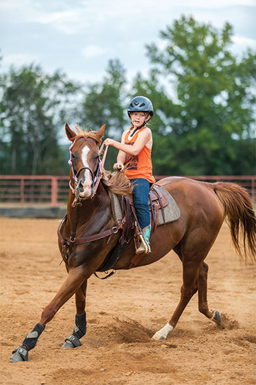Ella rides a horse