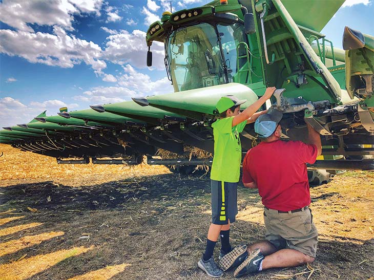 Trey and Todd maintain the harvester