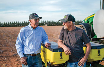 Sam Stanley, left, and his cousin, Len, prepare for planting season on their Levelland, Texas, cotton farms.
