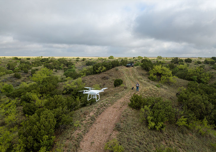 Coy Franks uses a drone to search for stray cattle