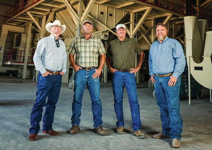 Randy Boman, Lance Williams, Mike Friemel and Carey McKinney stand in a cotton gin