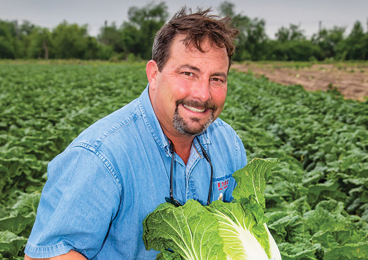 Tommy Hanka chops a napa cabbage