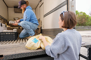 Jason readies meat, eggs, raw milk and other products for delivery