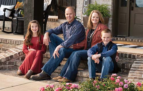 photo of the Vowell family sitting on their front porch