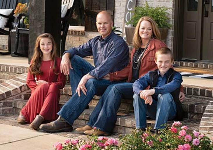 photo of the Vowell family sitting on their front porch