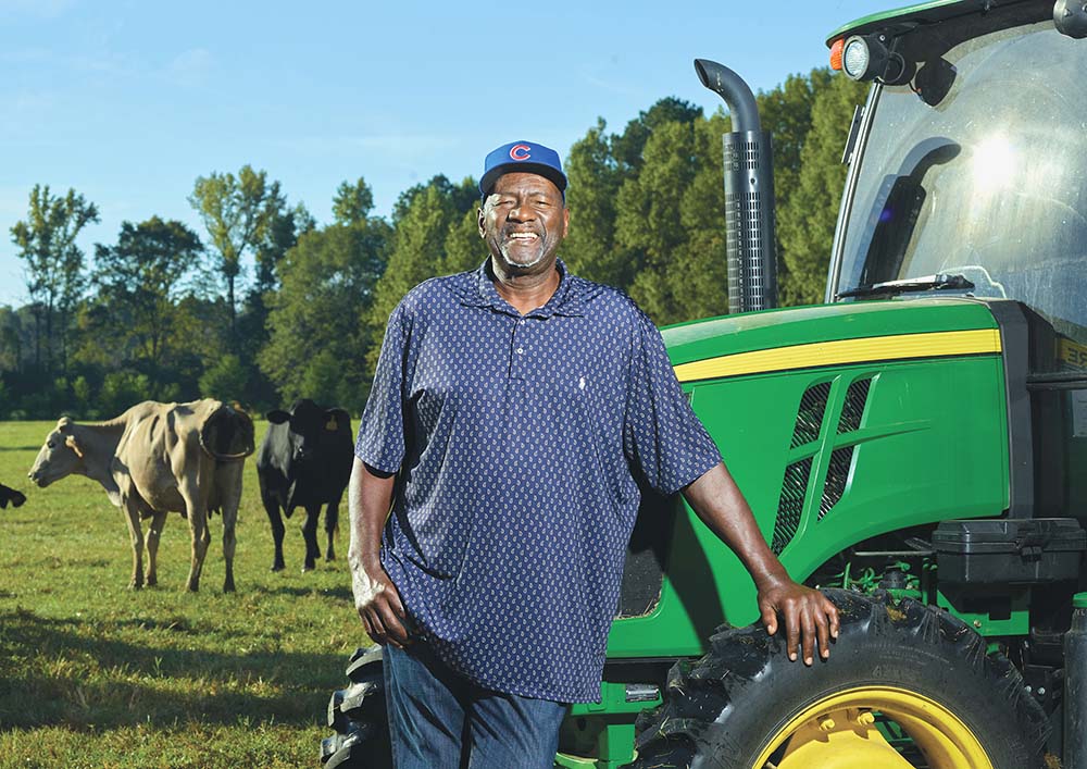 photo of retired baseball player Lee Smith in front of his tractor and cattle