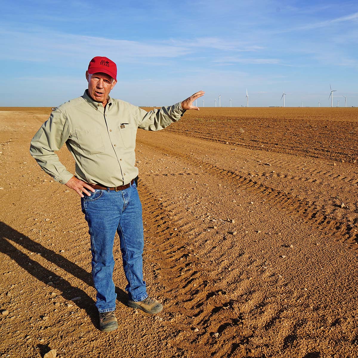 Carl Pepper stands in a field