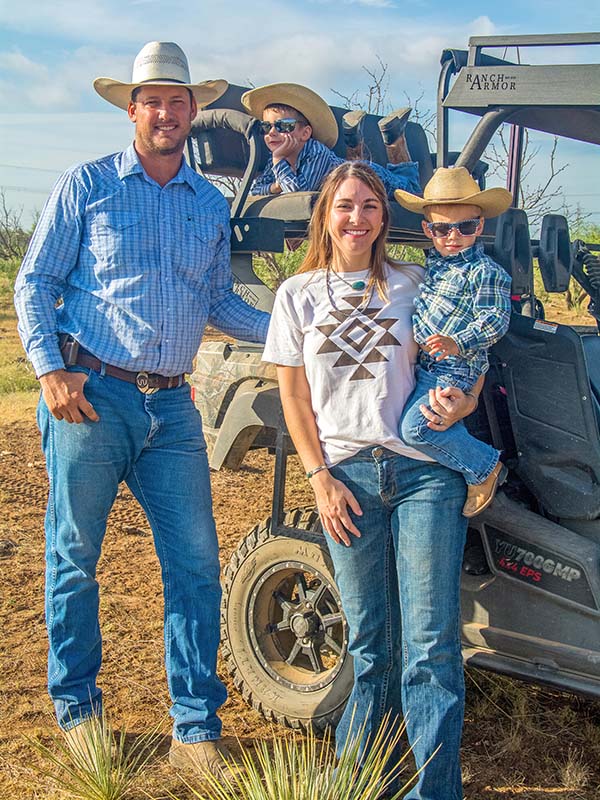 The Whitworth family standing next to ATVs at their ranch