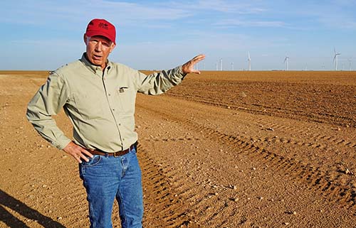 Carl Pepper stands on his property