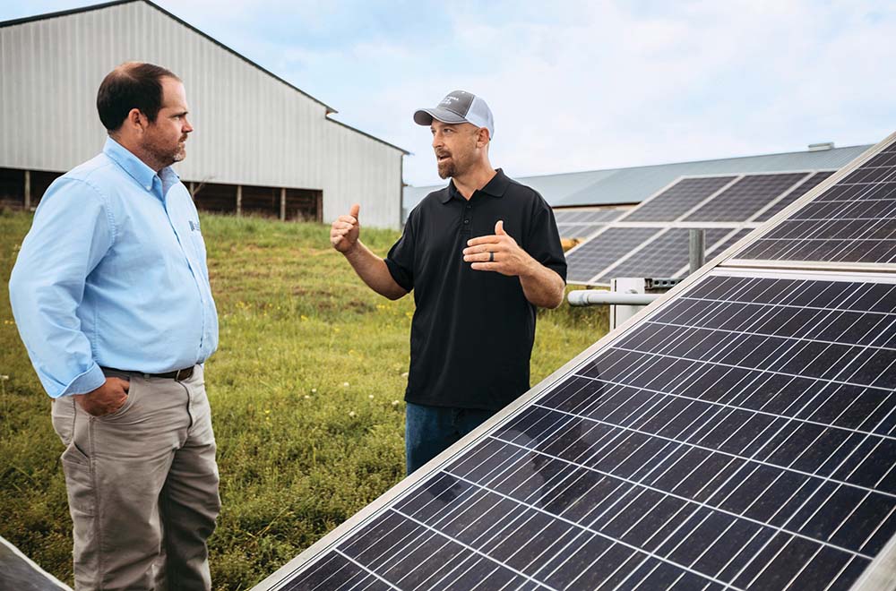 Matt Lee and Chuck Roberts standing next to solar panels