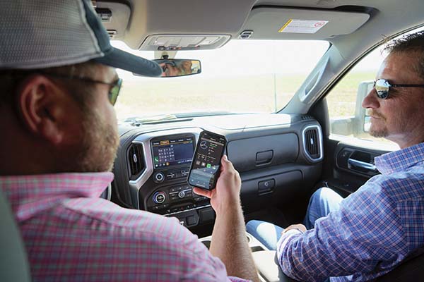 Cody Hughes and Jason Jones in the cab of his truck