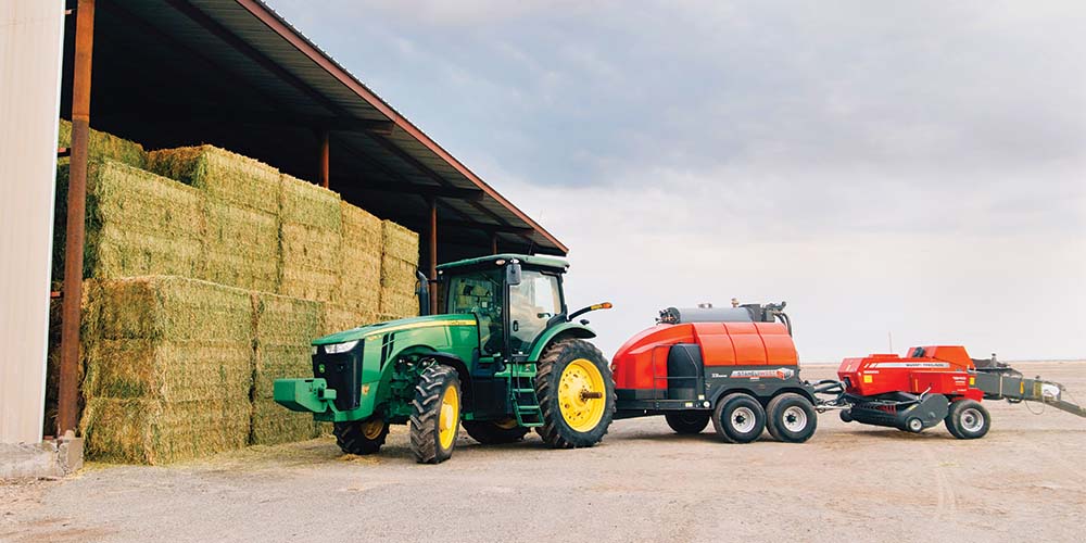 Tractor next to hay bales