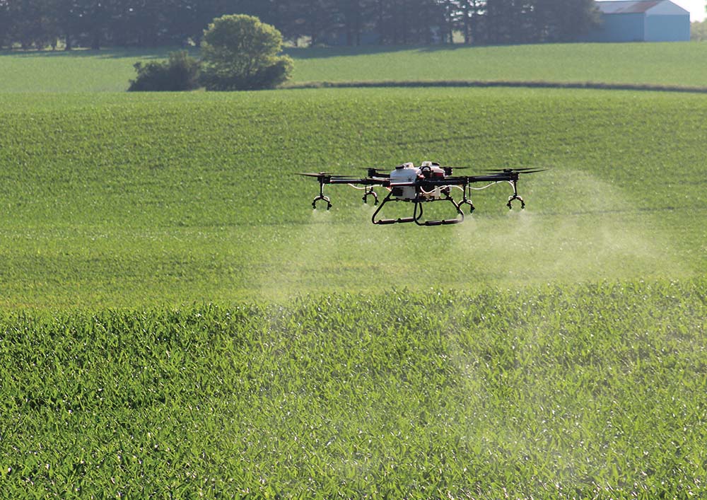 One of Hylio's drones sprays over a field