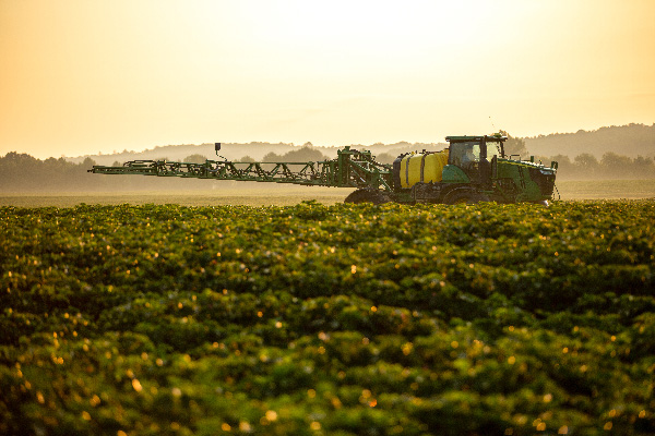 Tractor with sprayer attachment at Oliver Farms