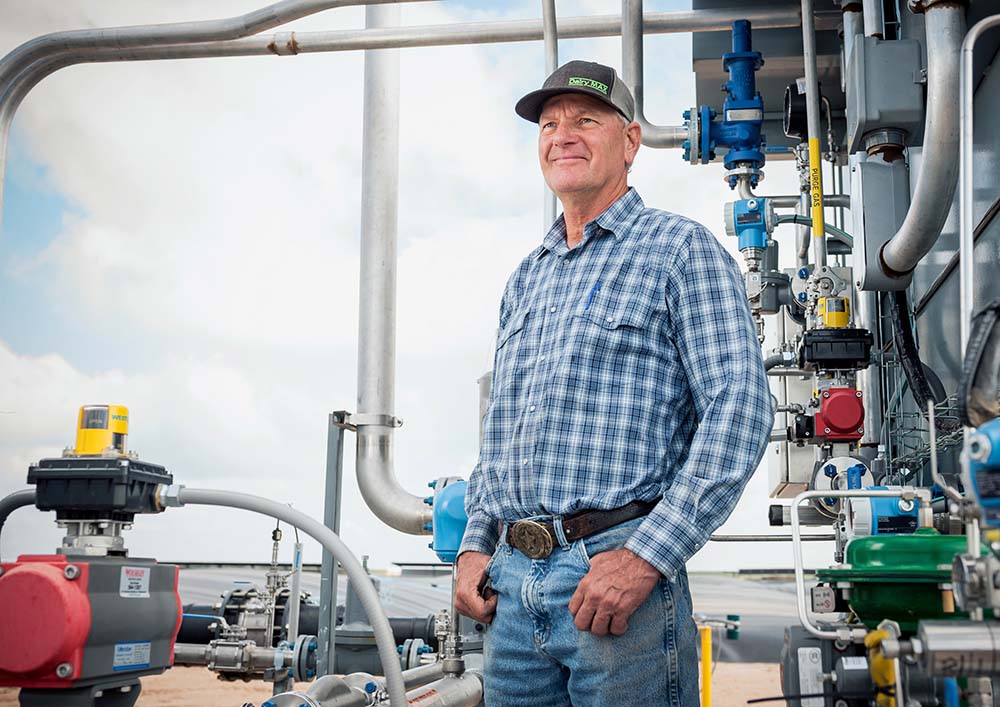 Sieto Mellema stands next to his methane digester equipment